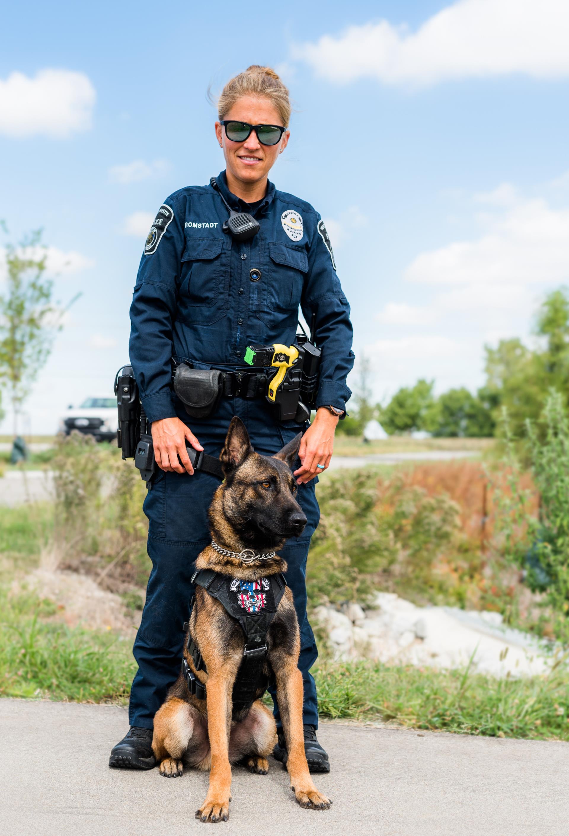 Police dog standing with a female officer