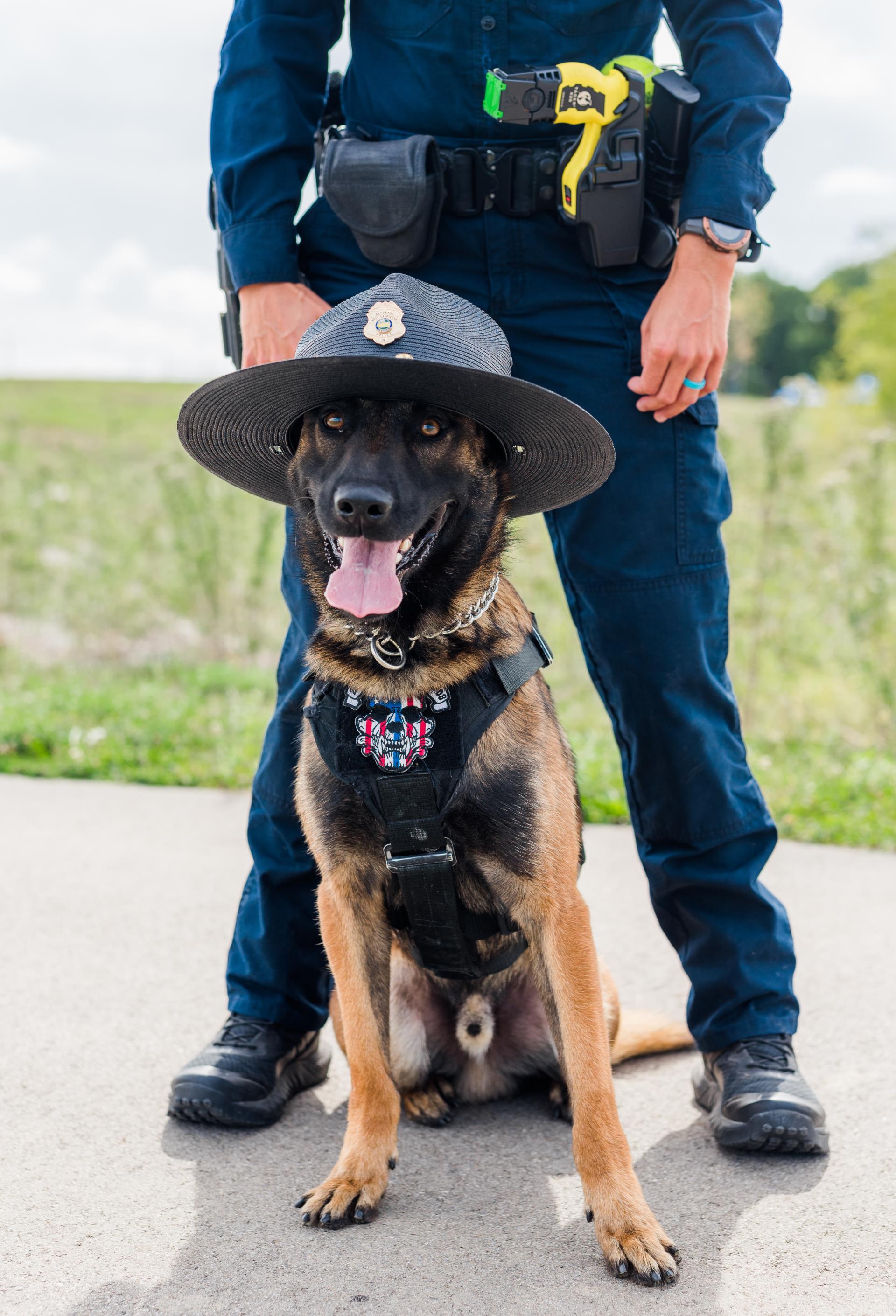 Police dog standing with a male officer